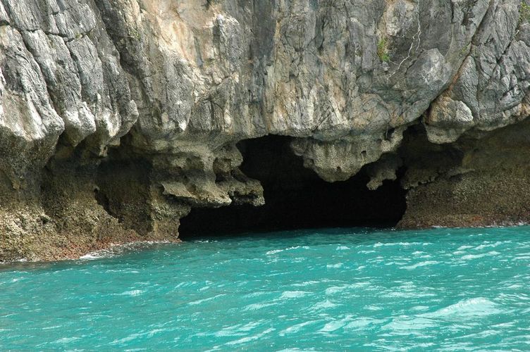 Deep caves in green waters.