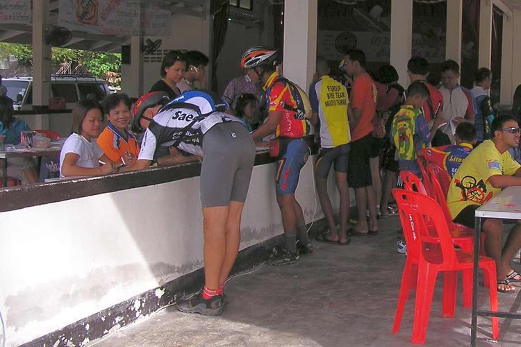 On the left is Mike of Red Bicycle signing up for the Koh Phangan 2004 MTB Race.