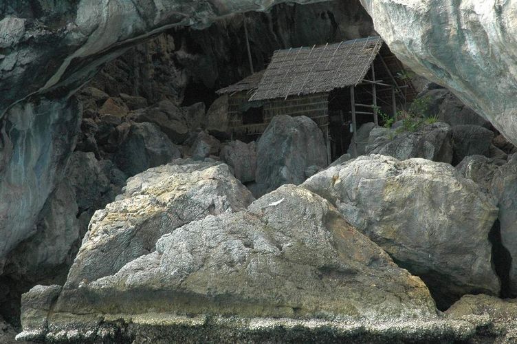Scenic thatched hut among boulders.